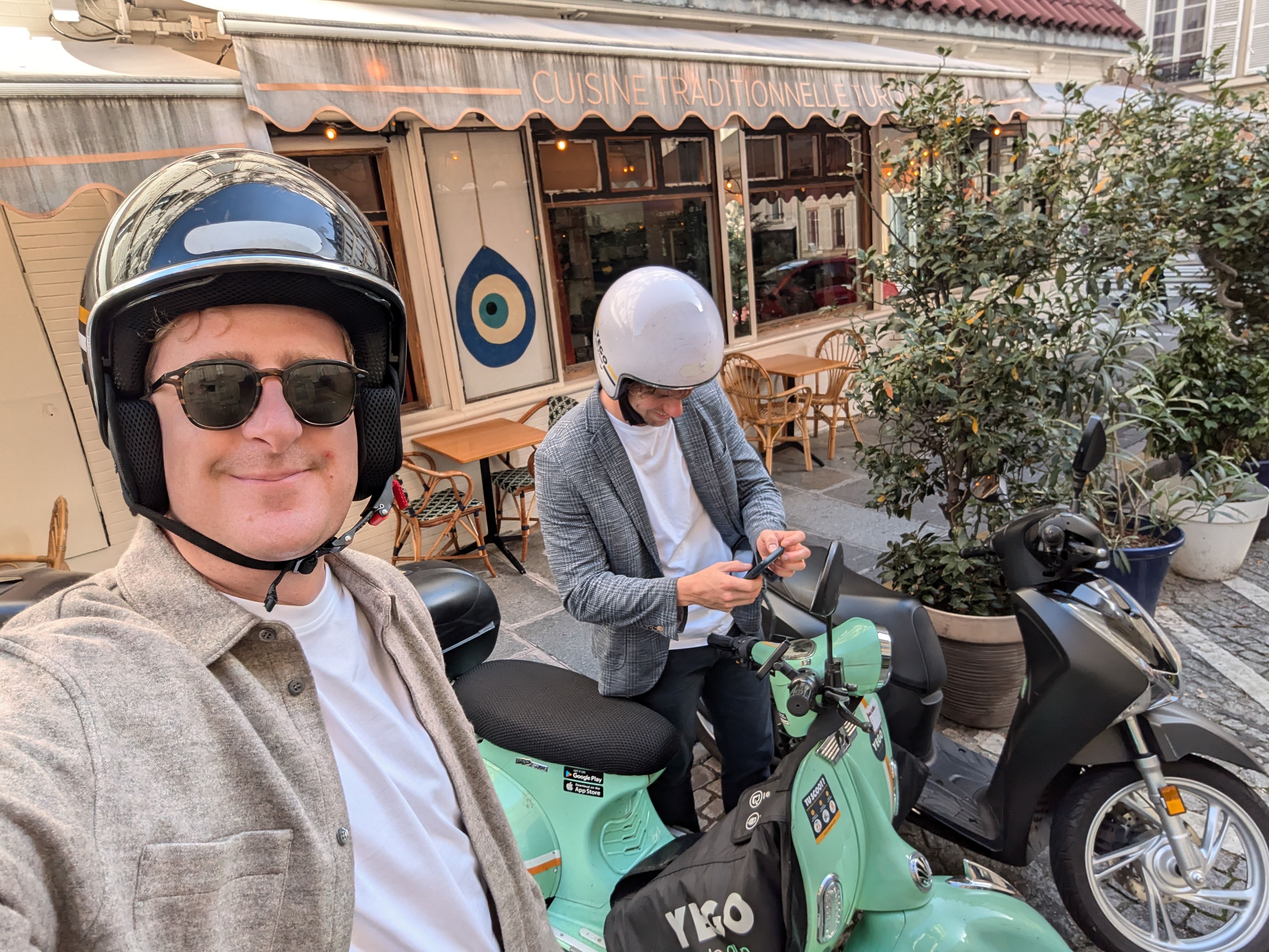 ARTSVP team riding green around Paris with electric scooter sharing.