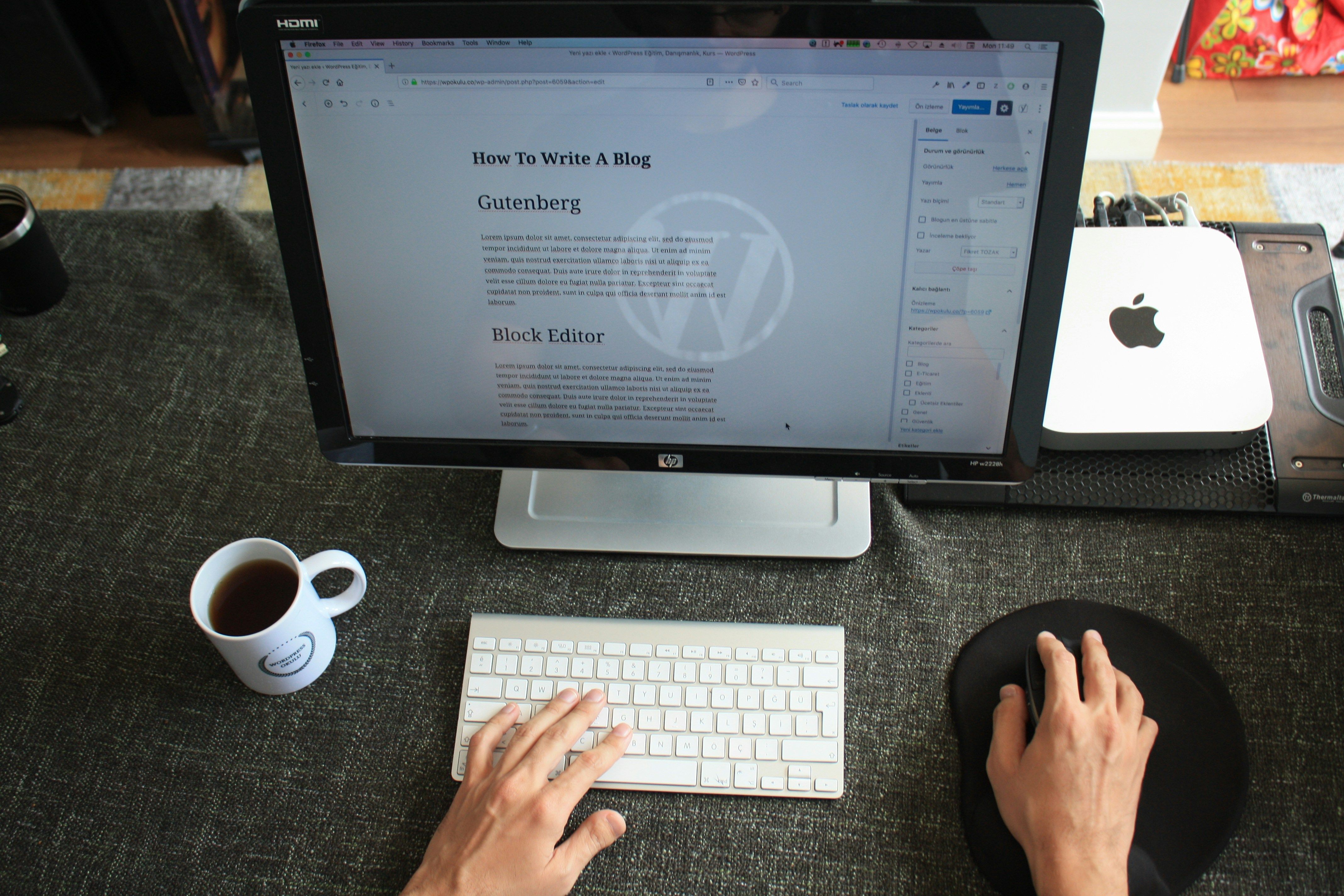 person writing a blog on a computer - Embed Medium Blog On Website