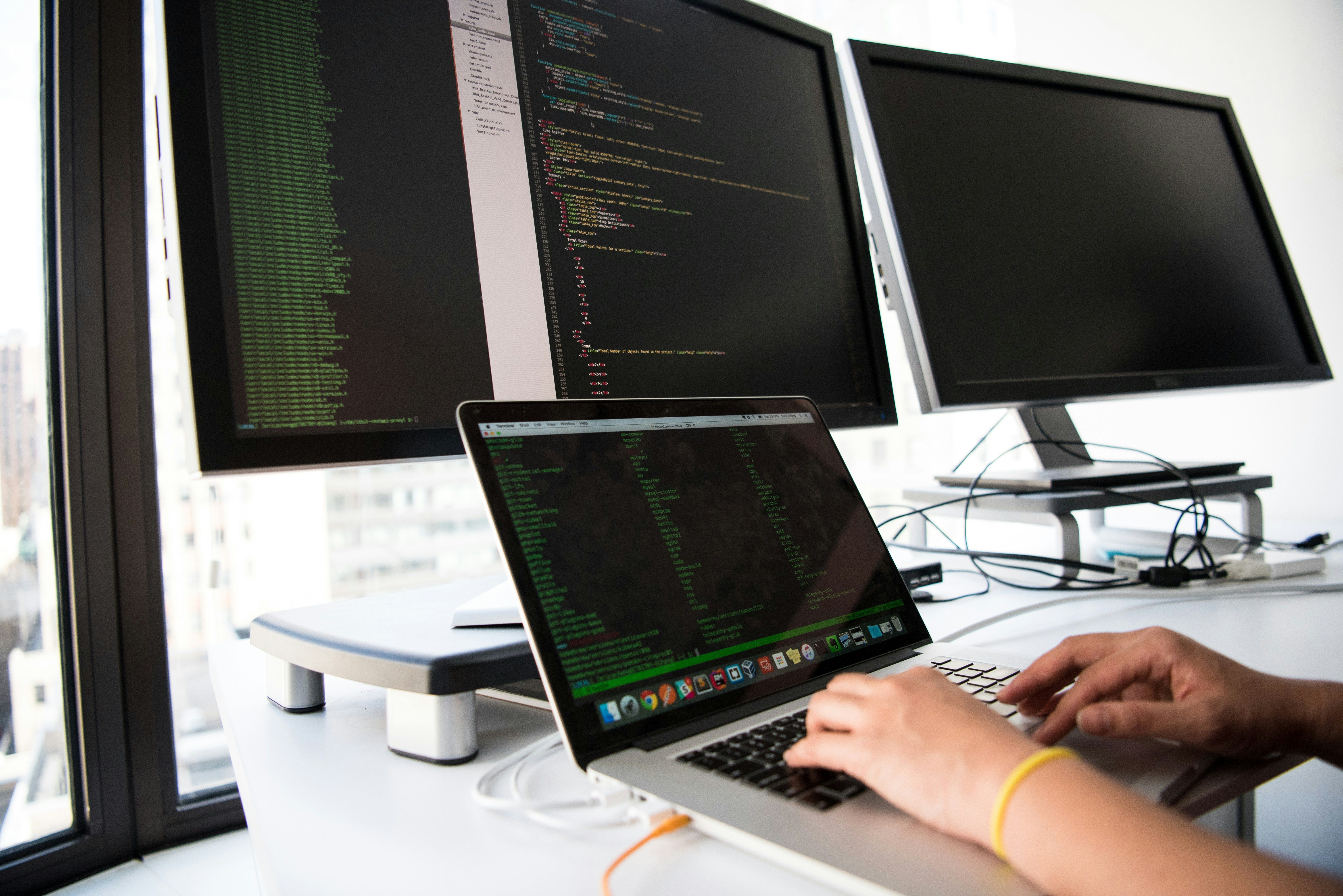person doing coding on laptop for Traditional CMS Vs Headless CMS