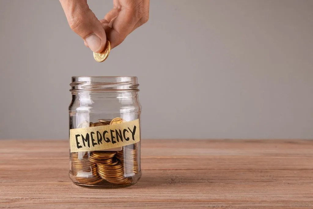 Putting coins into an emergency jar