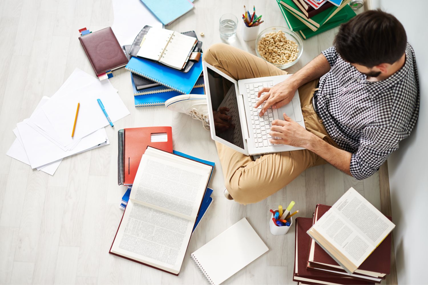 A person reading books and research papers about boosting melatonin.
