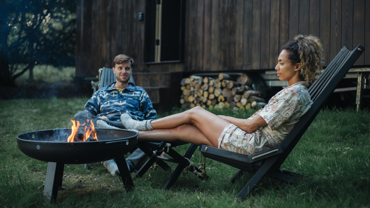 Sitting by the open fire pit at Unplugged Cabin