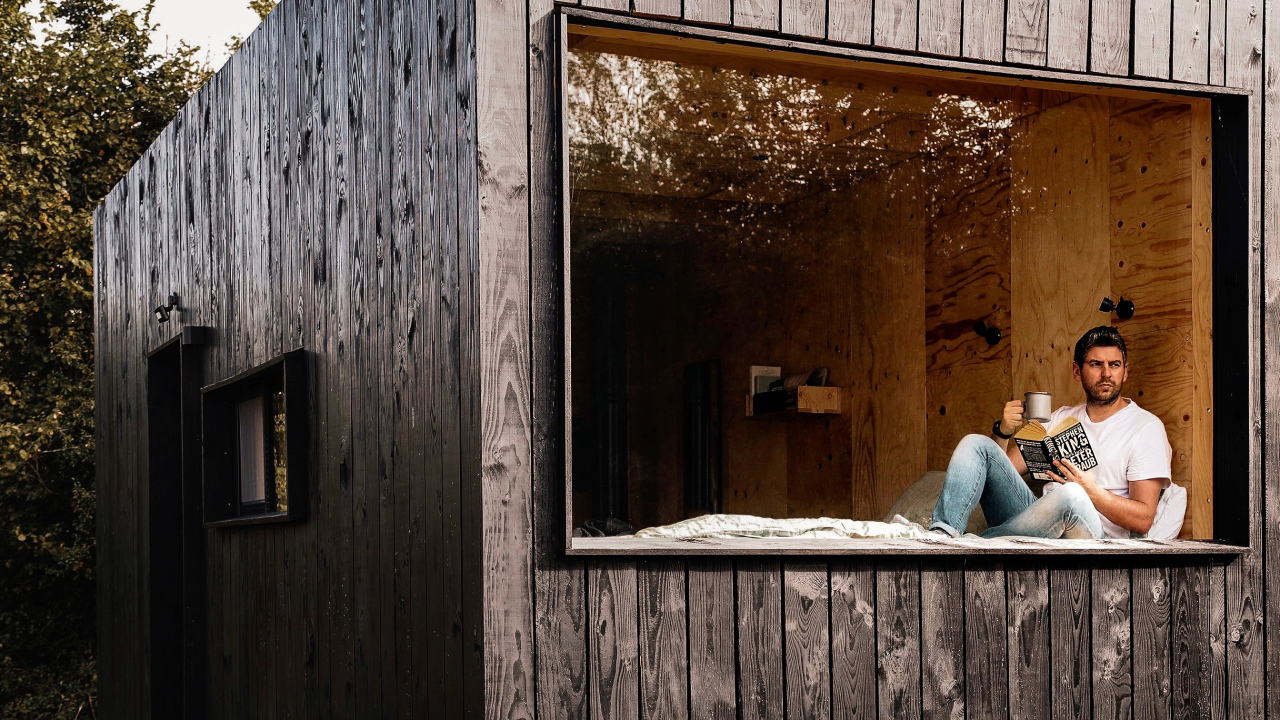 Lee Scarratt in reading nook at Unplugged Cabin